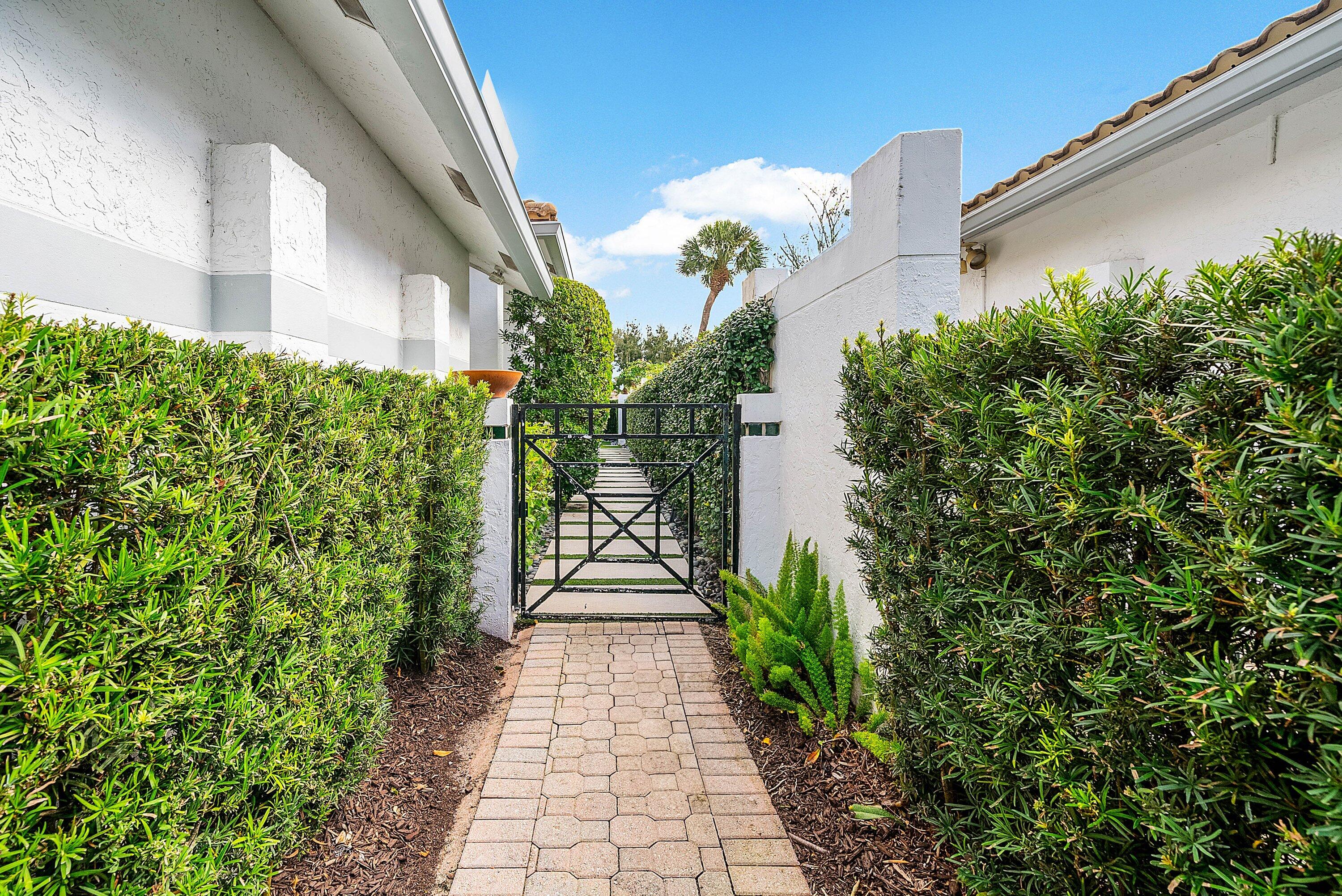 2224 Northwest 62nd Drive Boca Raton, FL 33496 - Photo 3 of 64 a view of a pathway with flower plants