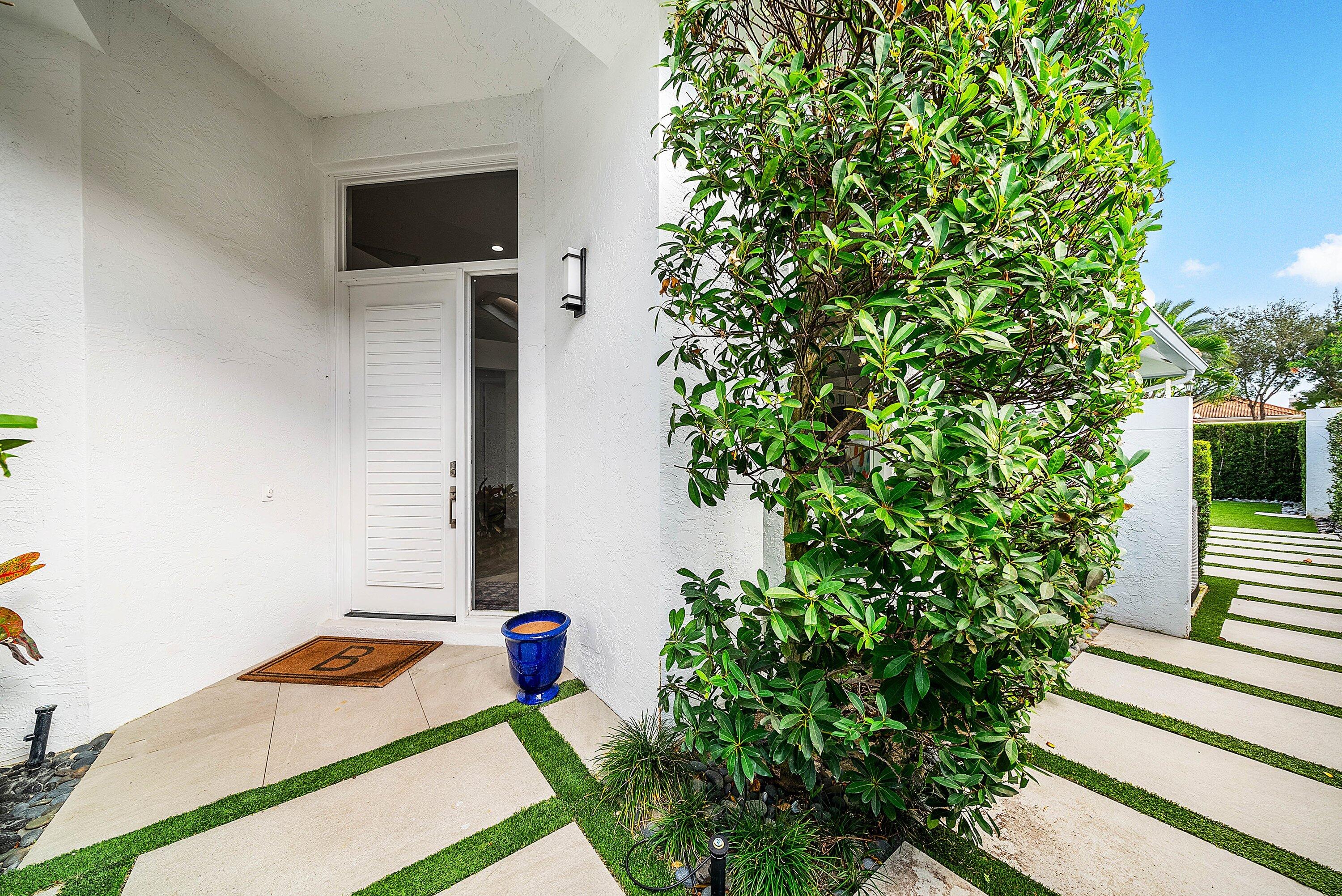 2224 Northwest 62nd Drive Boca Raton, FL 33496 - Photo 4 of 64 a front view of a house with entryway