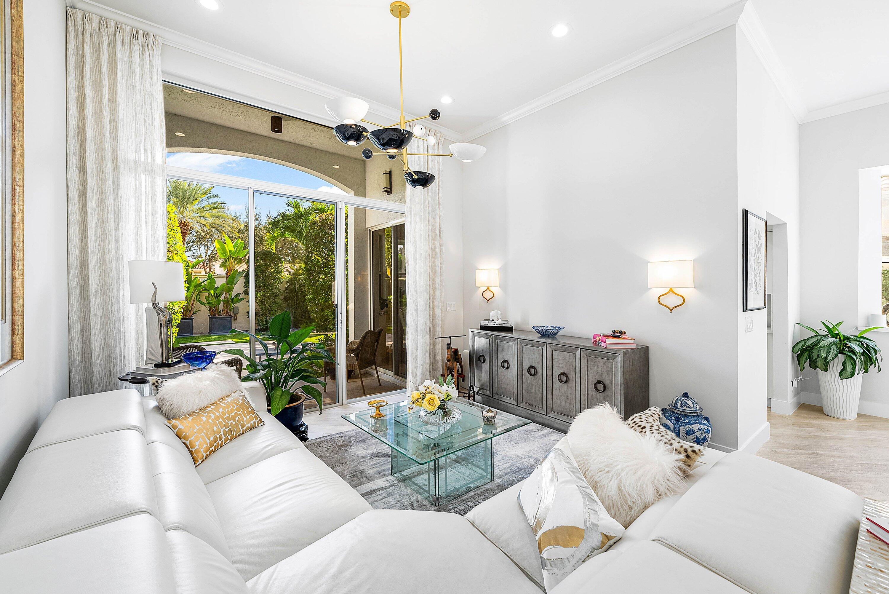 2224 Northwest 62nd Drive Boca Raton, FL 33496 - Photo 8 of 64 a living room with furniture chandelier and a large window