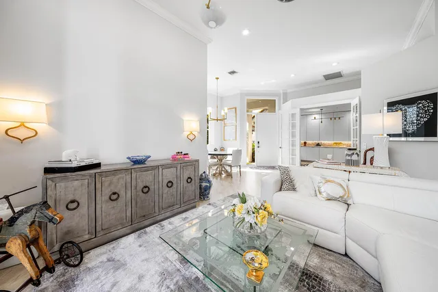 a view of a hallway with wooden floor and furniture