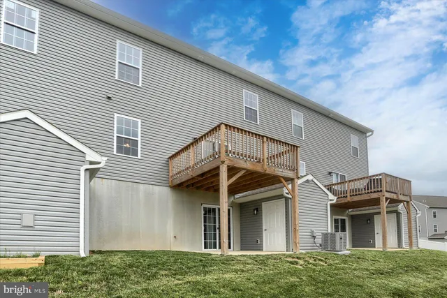 a view of a house with a yard and deck
