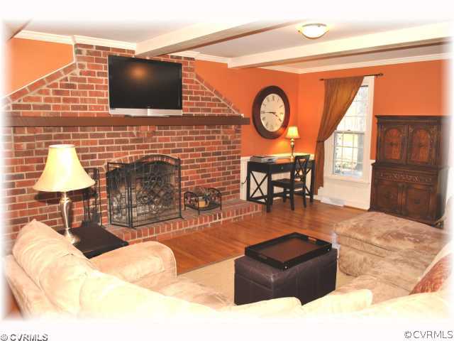 2539 Kentford Road Midlothian, VA 23113 - Photo 4 of 12 a living room with fireplace furniture and a flat screen tv