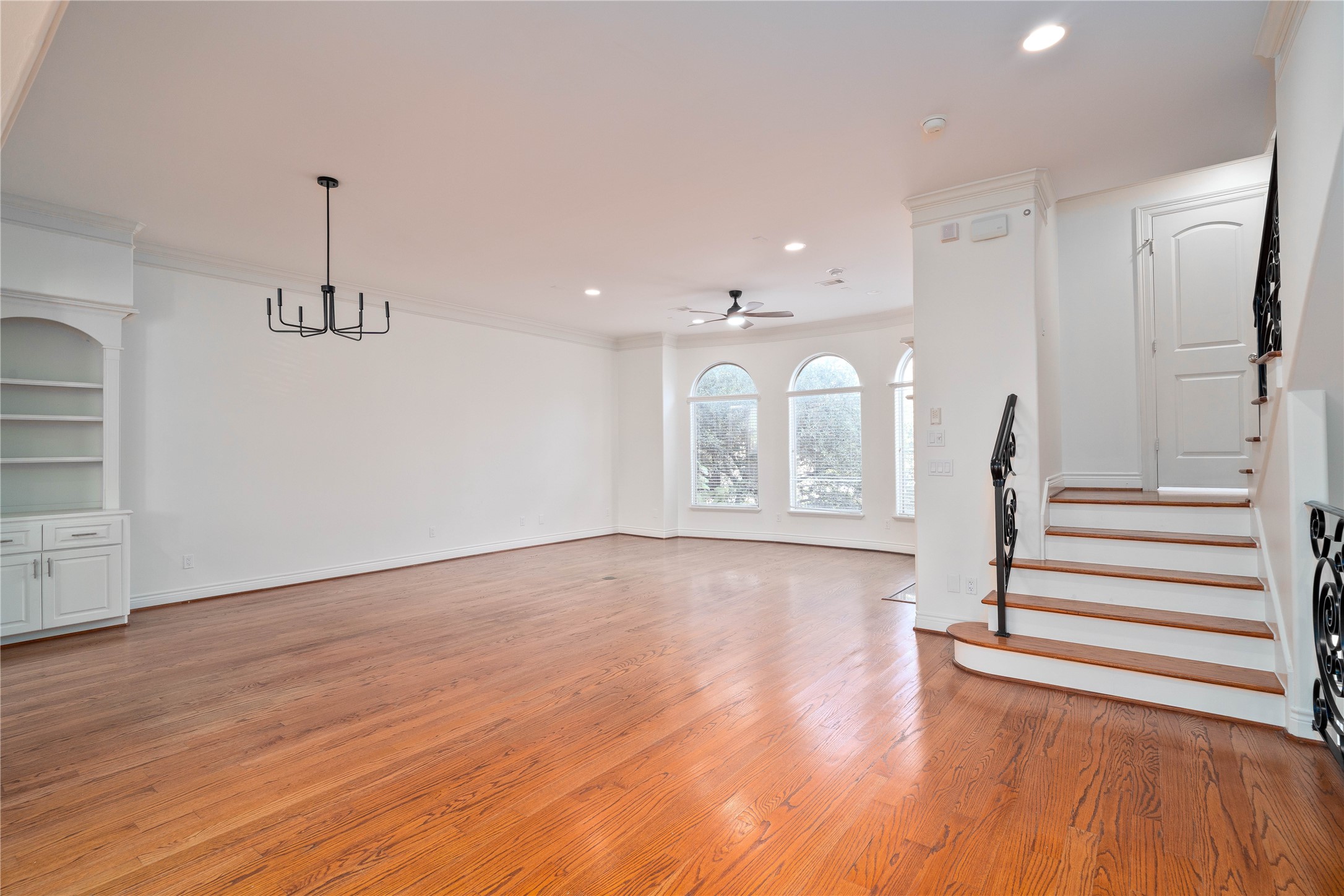 704 Welch Street Houston, TX 77006 - Photo 11 of 23 a view of entryway with wooden floor and stairs