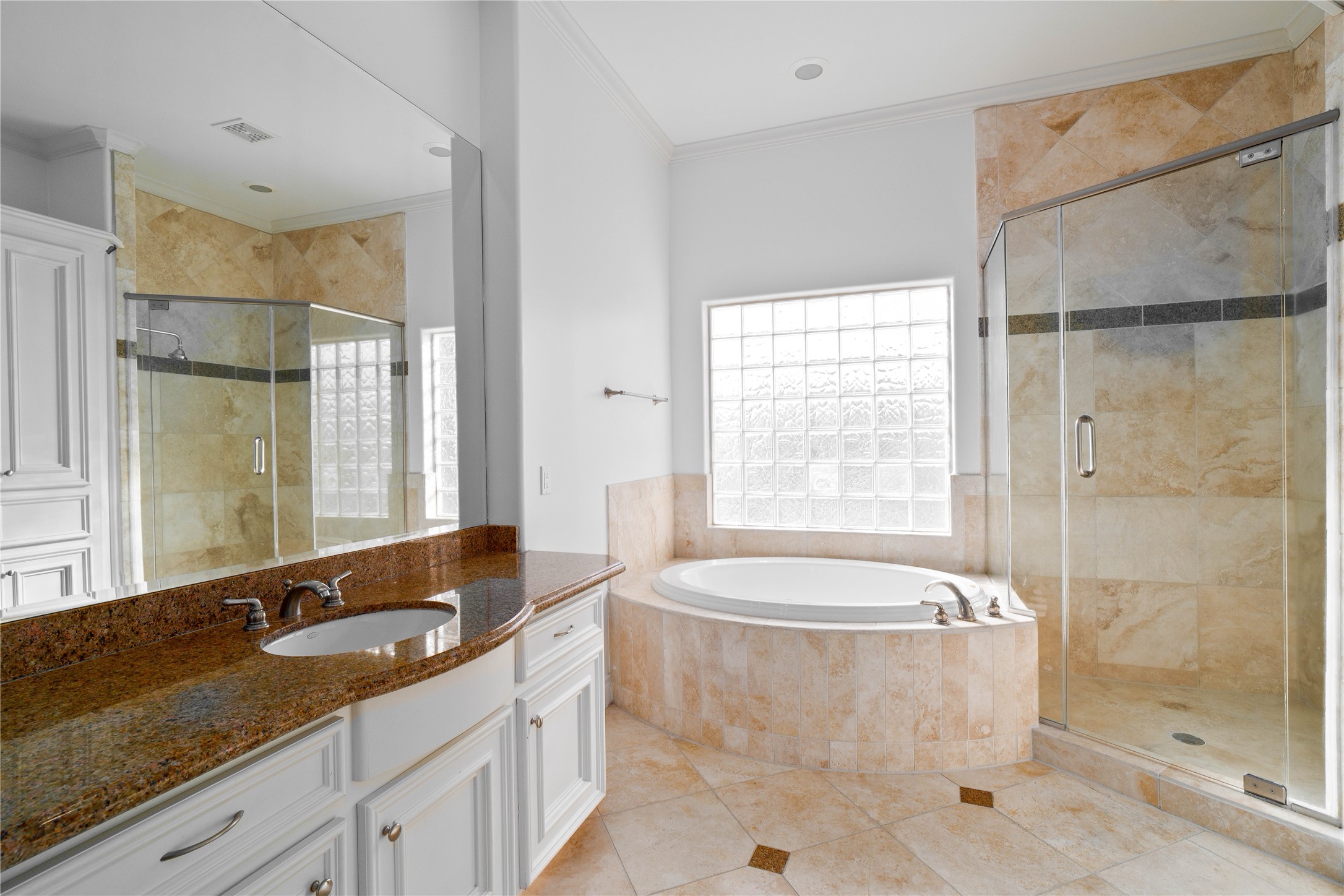 704 Welch Street Houston, TX 77006 - Photo 2 of 23 a bathroom with a granite countertop bathtub shower sink and mirror