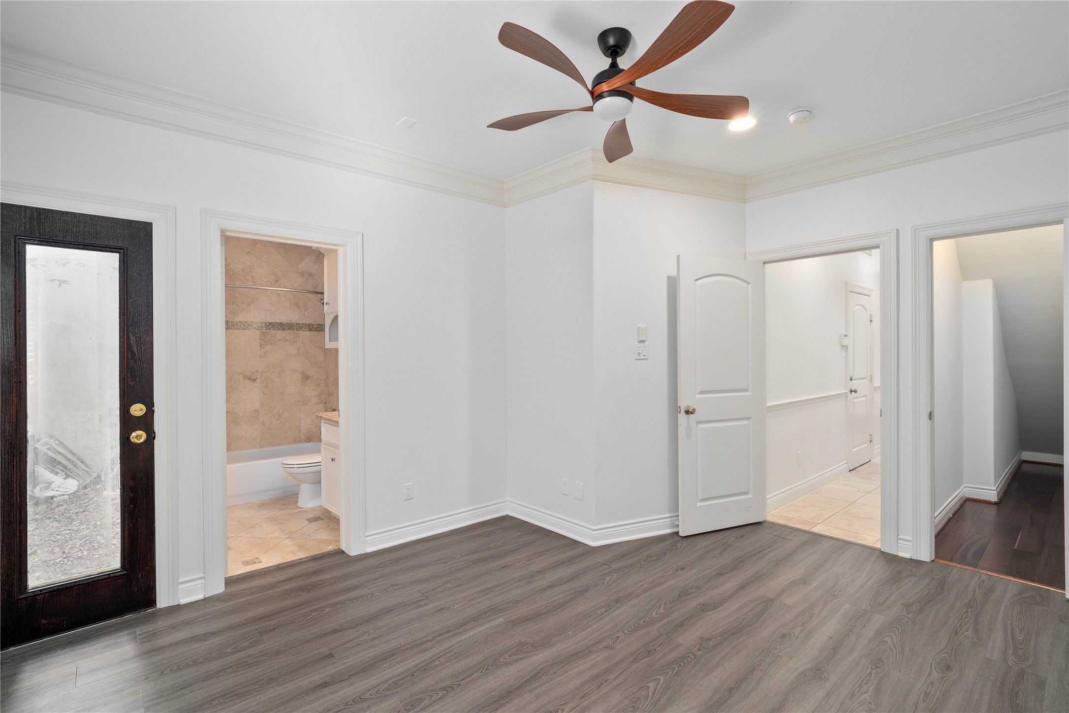 704 Welch Street Houston, TX 77006 - Photo 6 of 23 a view of a livingroom with wooden floor and a ceiling fan