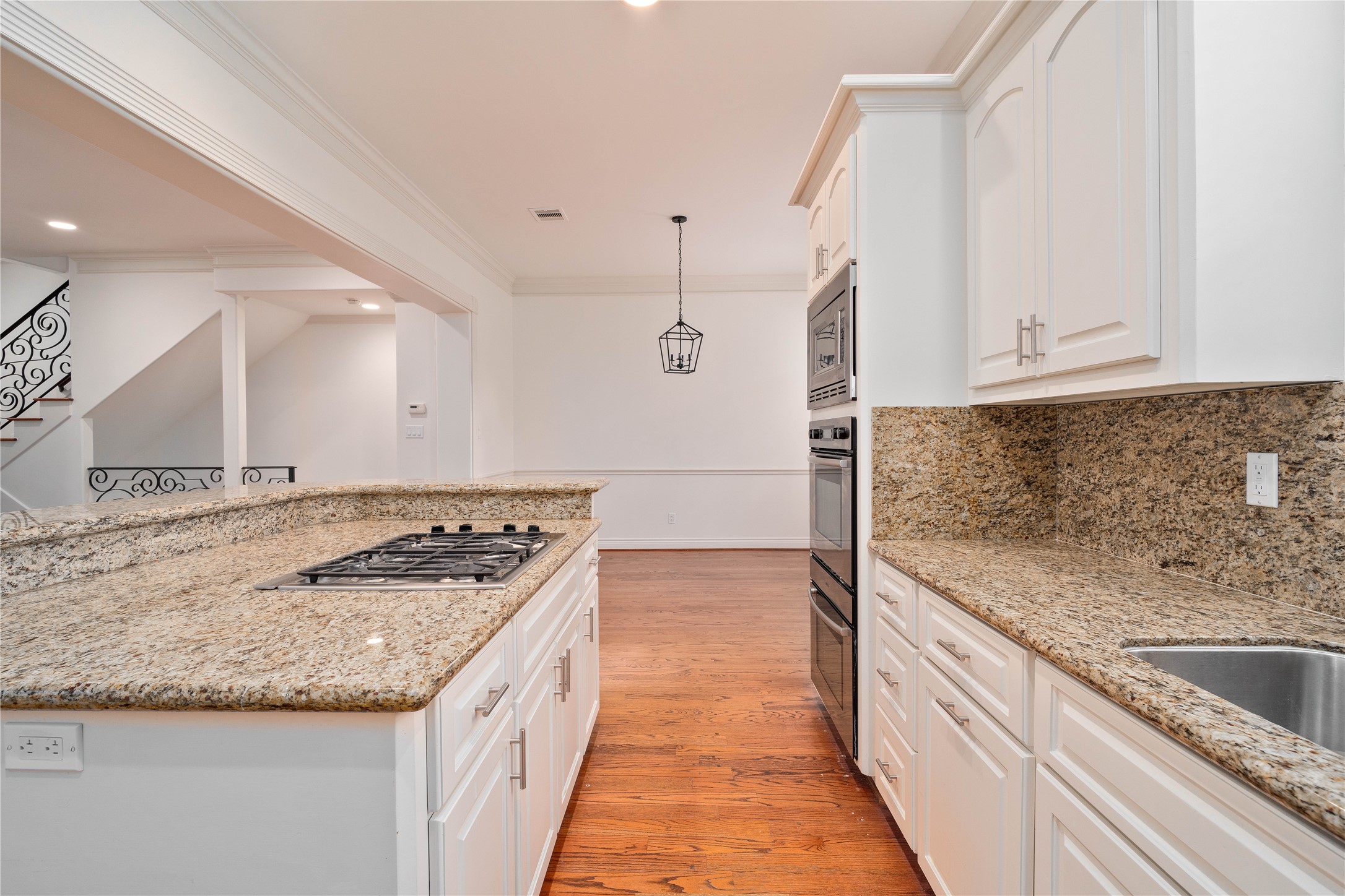 704 Welch Street Houston, TX 77006 - Photo 9 of 23 a kitchen with granite countertop a sink stove and cabinets