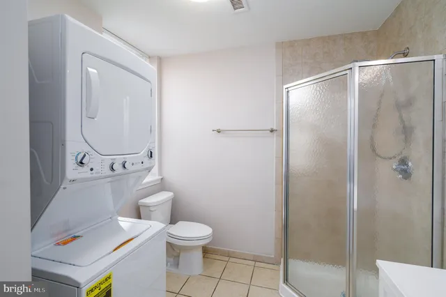 a bathroom with a toilet a sink and a shower