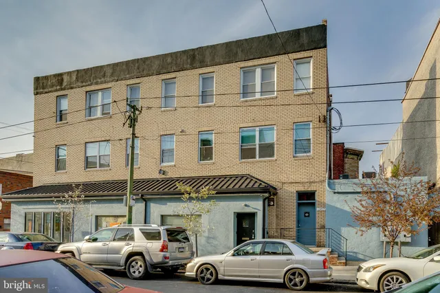 a front view of a building with parking space