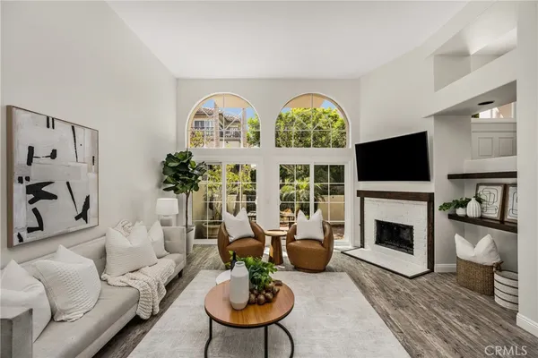 a living room with furniture a fireplace and a flat screen tv