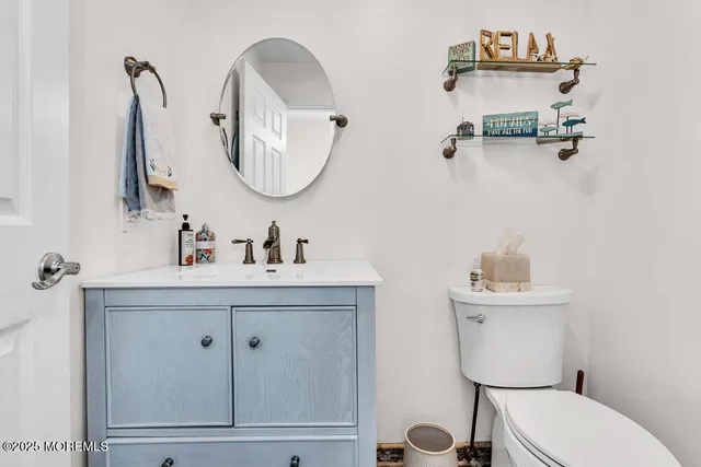 a bathroom with a toilet a sink and mirror