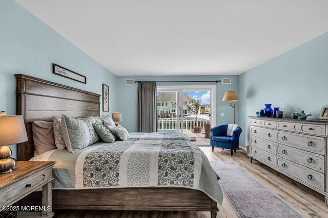 a bedroom with a bed and large window