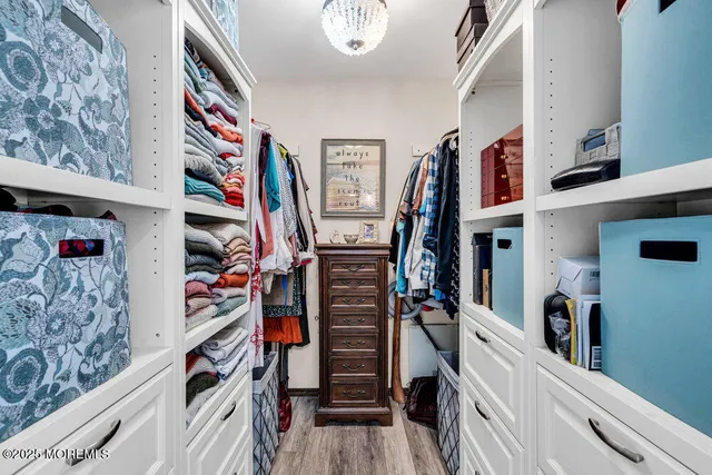 a view of walk in closet with clothes