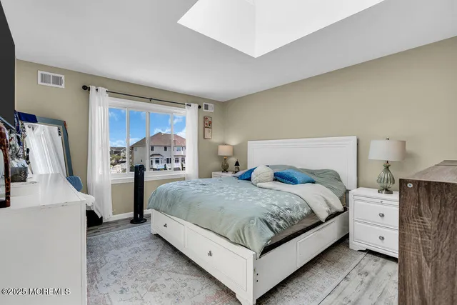 a bedroom with a bed and a night stand