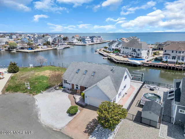 an aerial view of a house with outdoor space and lake view in back