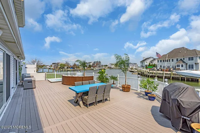 a view of a rooftop deck with couch and chairs