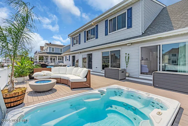 a view of a patio with couches table and chairs and potted plants