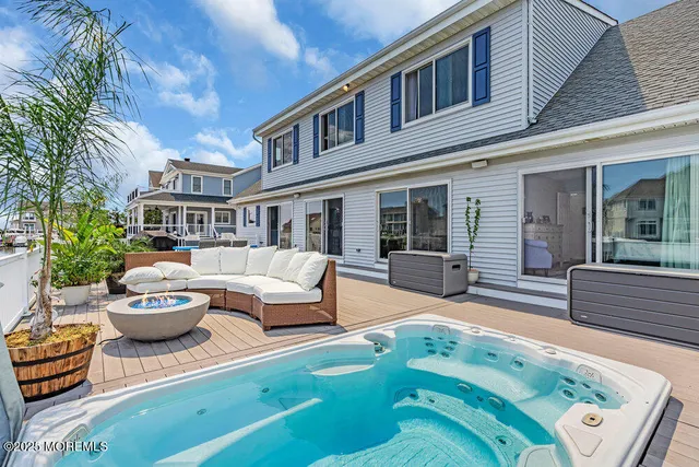 a view of a patio with couches table and chairs and potted plants