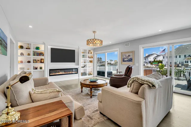 a living room with fireplace furniture and a flat screen tv