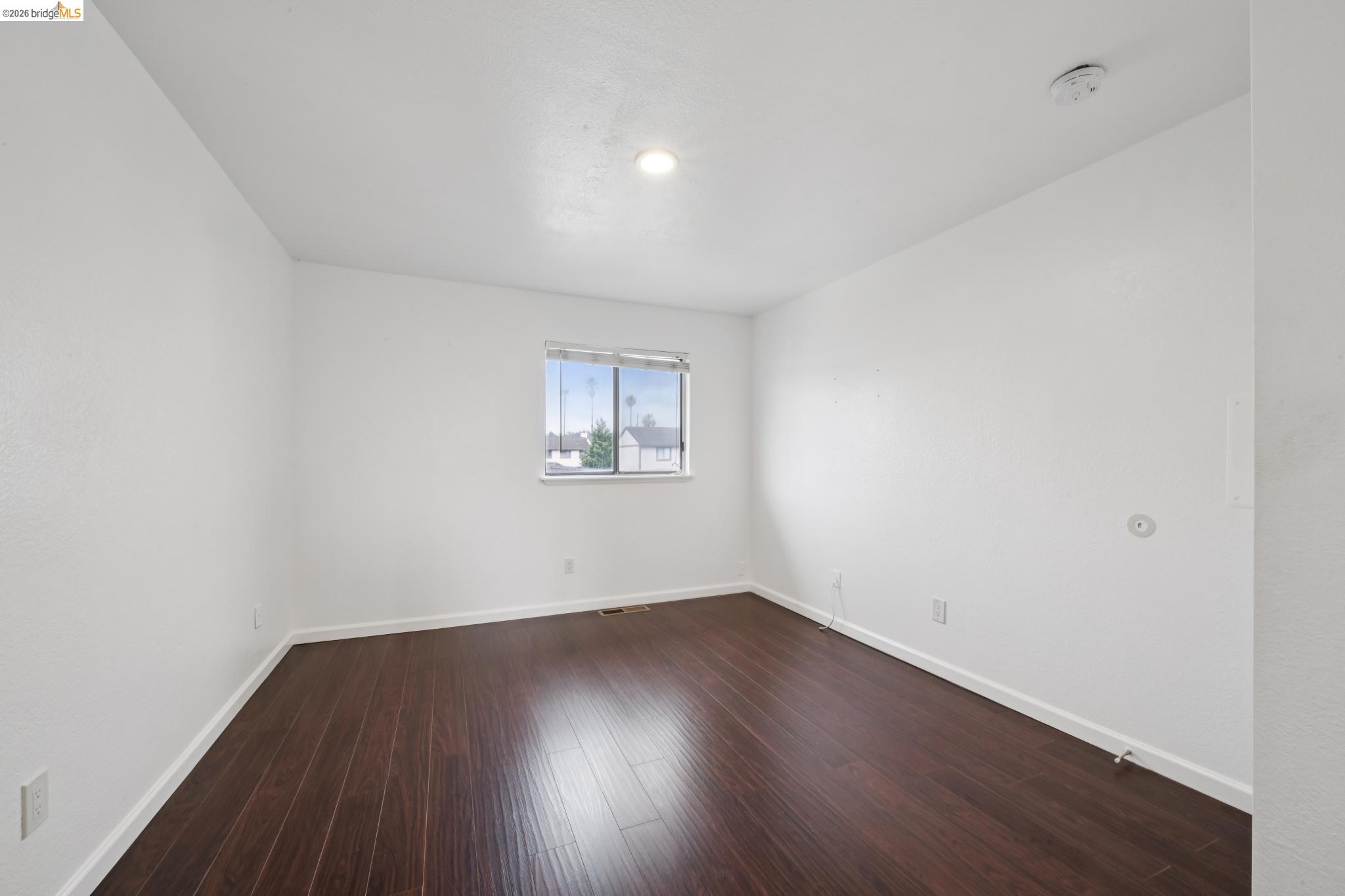 2600 Giant Road, Unit 35 San Pablo, CA 94806 - Photo 10 of 15 an empty room with wooden floor and windows
