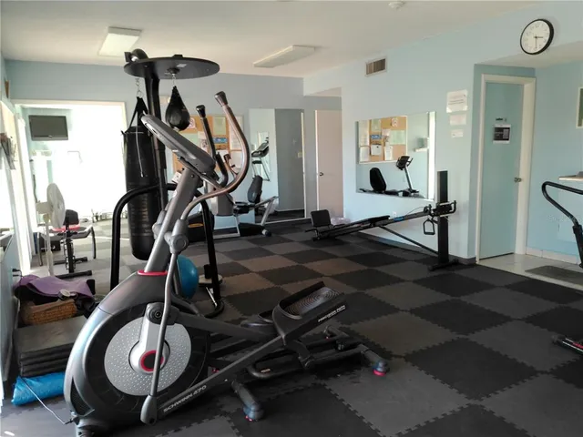 a kitchen with stainless steel appliances kitchen island granite countertop a sink dishwasher stove and cabinets