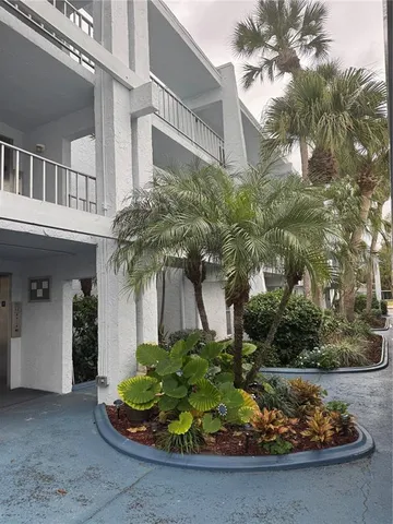 a room with wooden floor pool table and windows