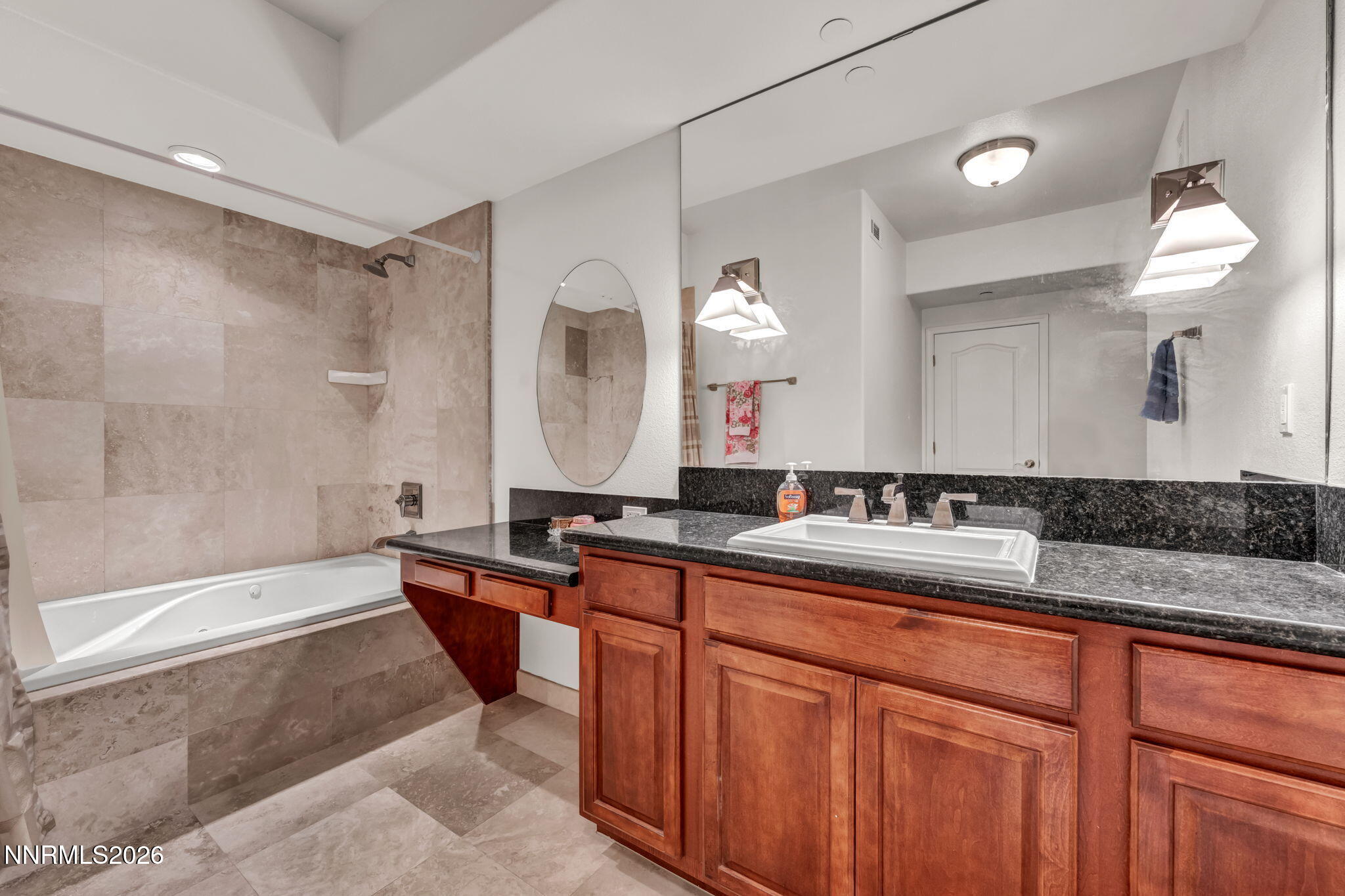 200 West 2nd Street, Unit 1103 Reno, NV 89501 - Photo 24 of 49 a bathroom with a sink a large mirror and a bathtub