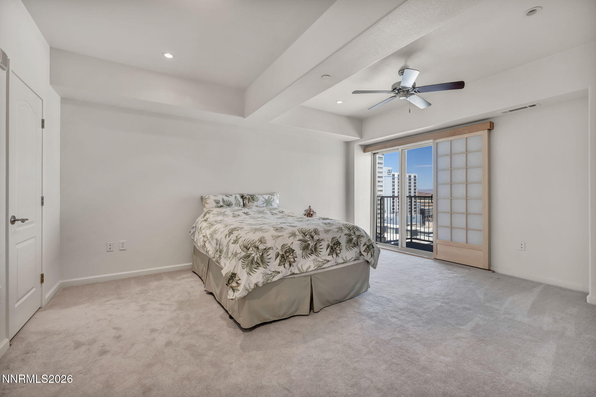 200 West 2nd Street, Unit 1103 Reno, NV 89501 - Photo 28 of 49 a spacious bedroom with a bed and a chandelier