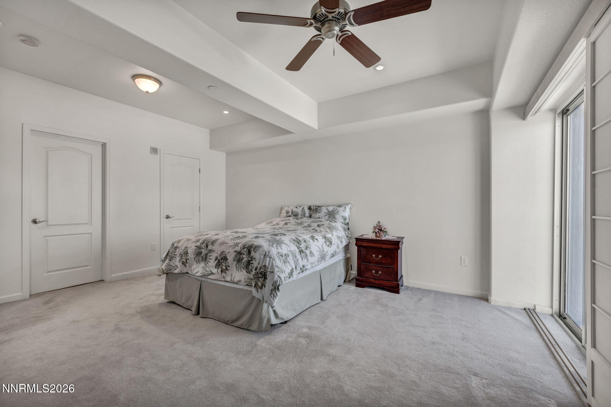 200 West 2nd Street, Unit 1103 Reno, NV 89501 - Photo 29 of 49 a spacious bedroom with a bed and a chandelier fan