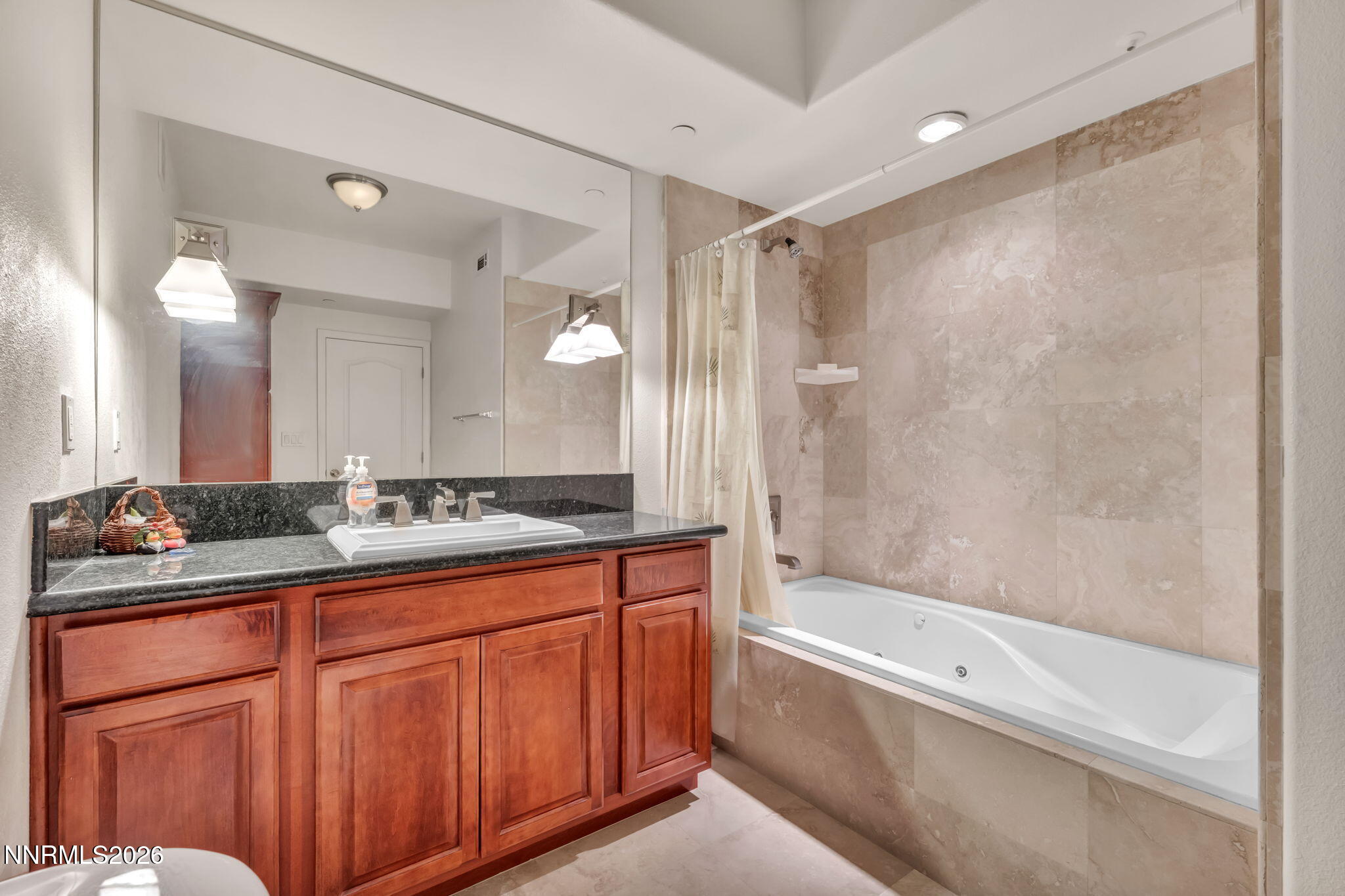 200 West 2nd Street, Unit 1103 Reno, NV 89501 - Photo 32 of 49 a bathroom with a granite countertop sink mirror bathtub and toilet