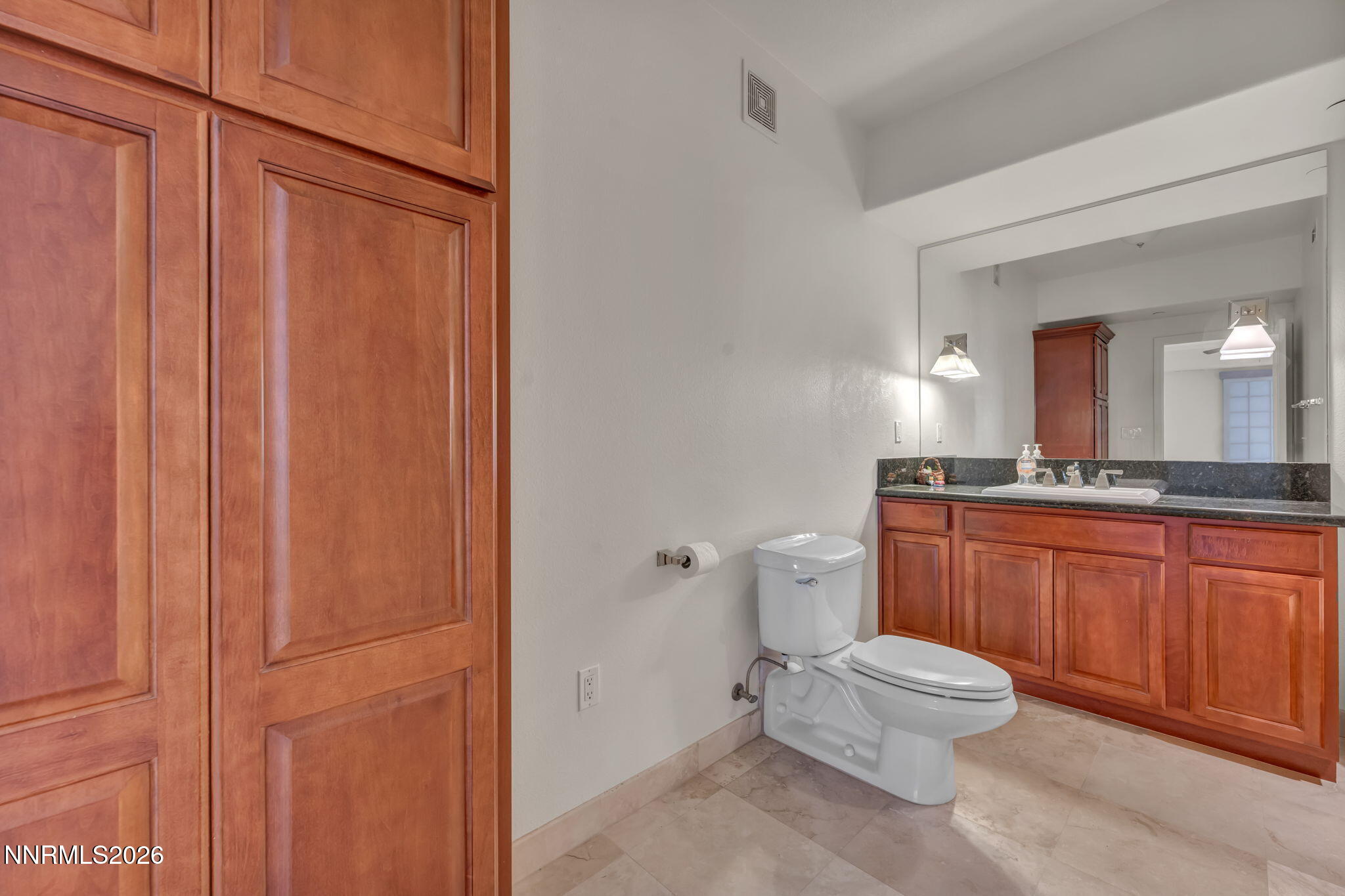 200 West 2nd Street, Unit 1103 Reno, NV 89501 - Photo 35 of 49 a bathroom with a toilet a sink and vanity