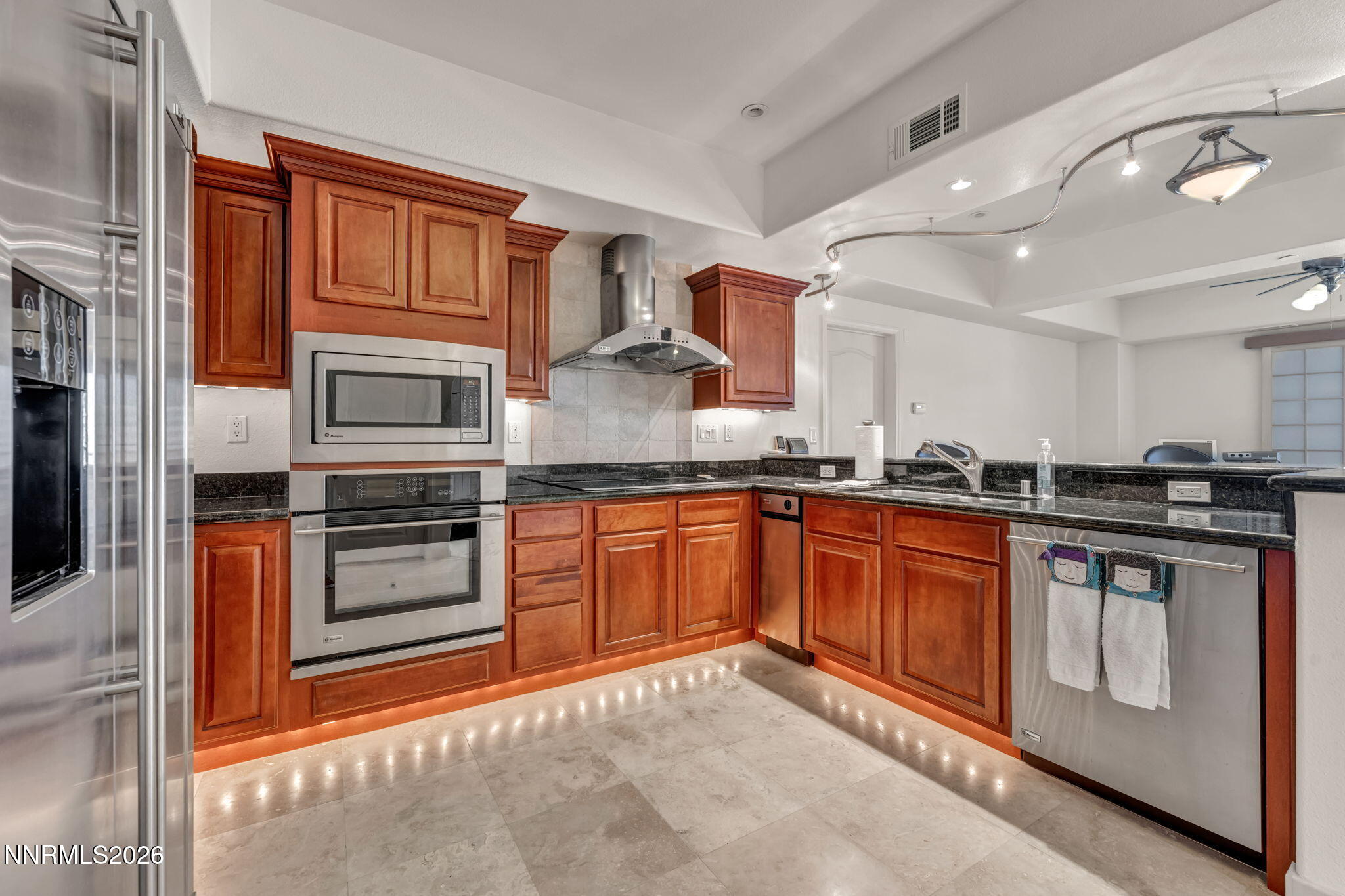 200 West 2nd Street, Unit 1103 Reno, NV 89501 - Photo 5 of 49 a large kitchen with stainless steel appliances granite countertop a stove a sink and a microwave