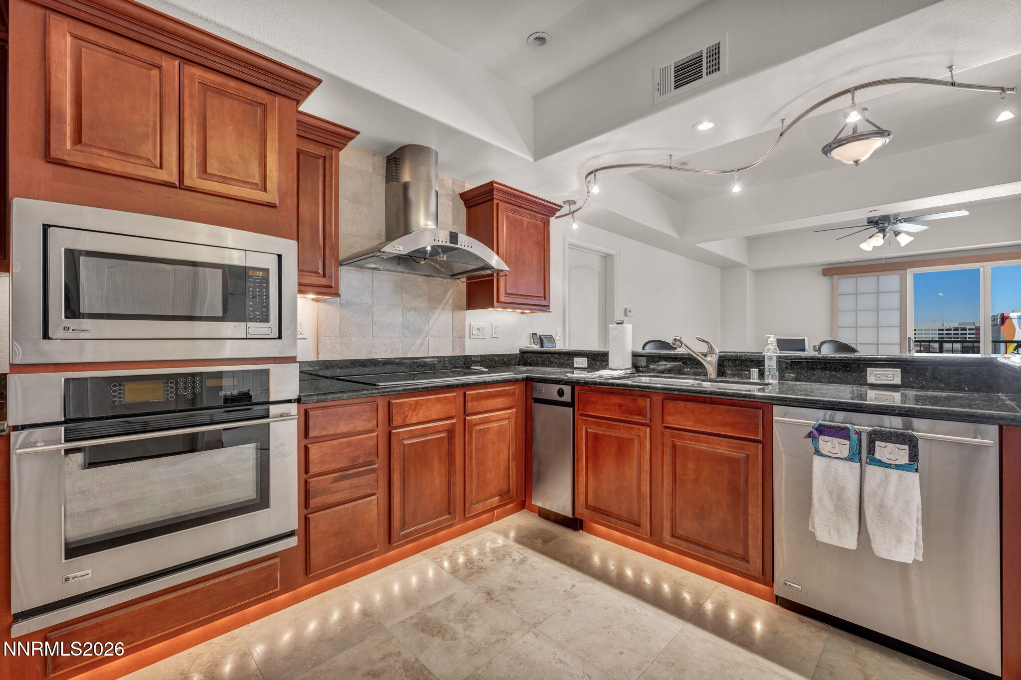200 West 2nd Street, Unit 1103 Reno, NV 89501 - Photo 7 of 49 a kitchen with stainless steel appliances granite countertop a stove microwave and cabinets
