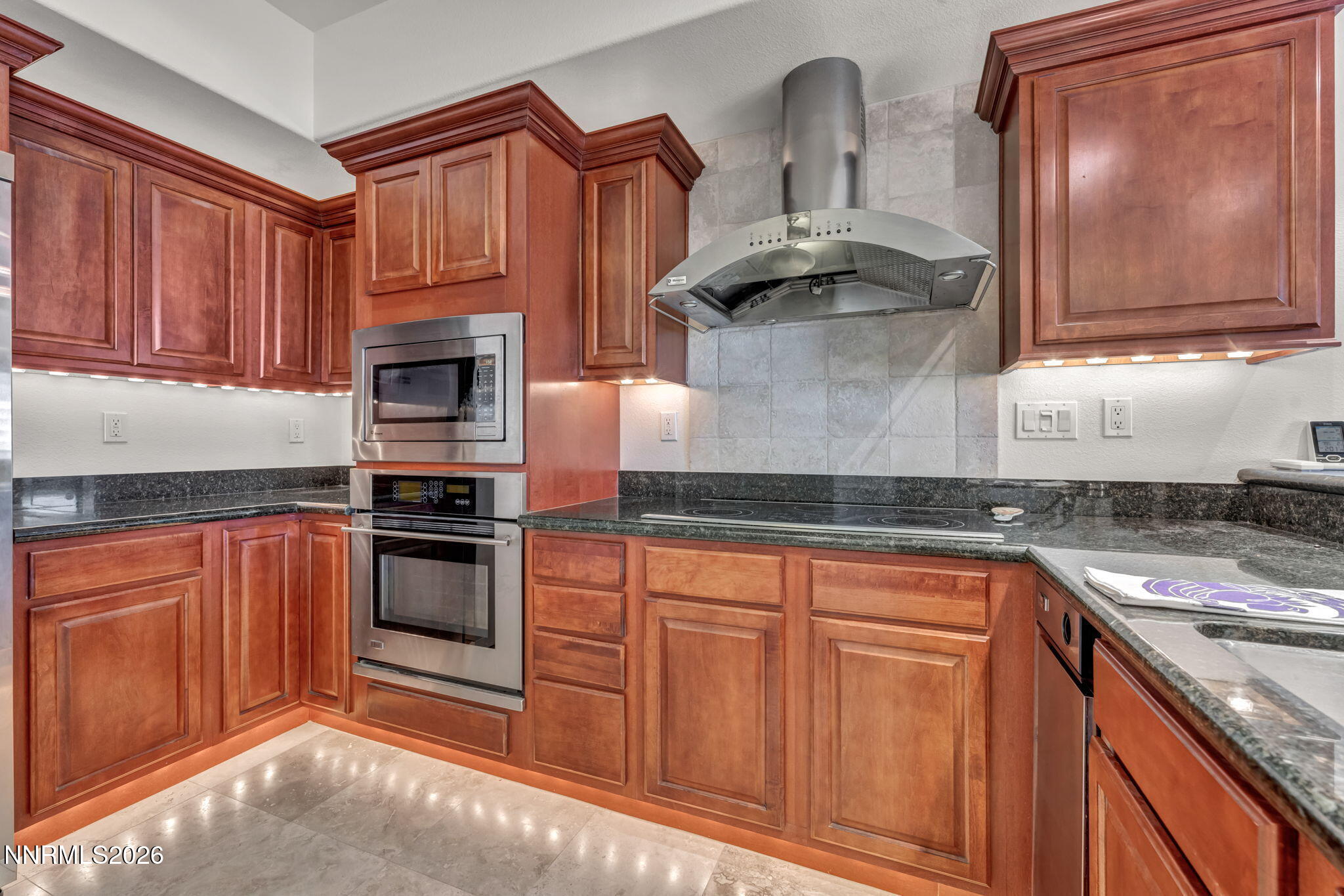 200 West 2nd Street, Unit 1103 Reno, NV 89501 - Photo 8 of 49 a kitchen with stainless steel appliances granite countertop a sink stove and cabinets