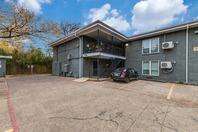 a car parked in front of a brick house