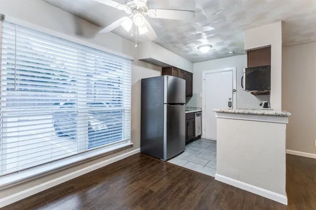 a view of a refrigerator in kitchen and wooden floor
