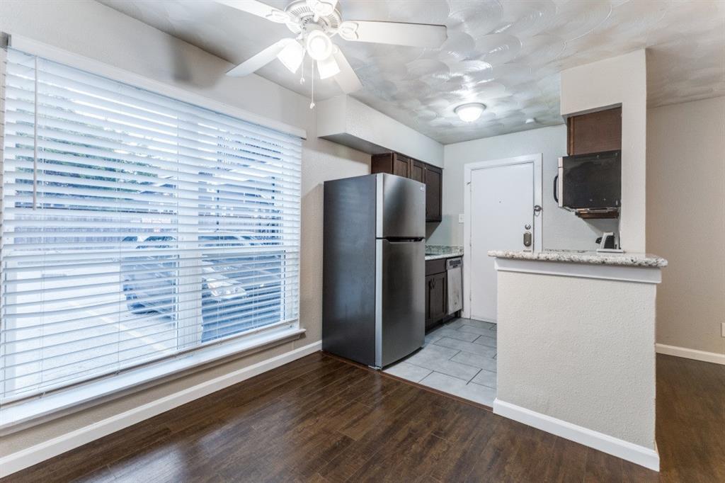 811 Skillman Street, Unit 105 Dallas, TX 75214 - Photo 8 of 13 a view of a refrigerator in kitchen and wooden floor