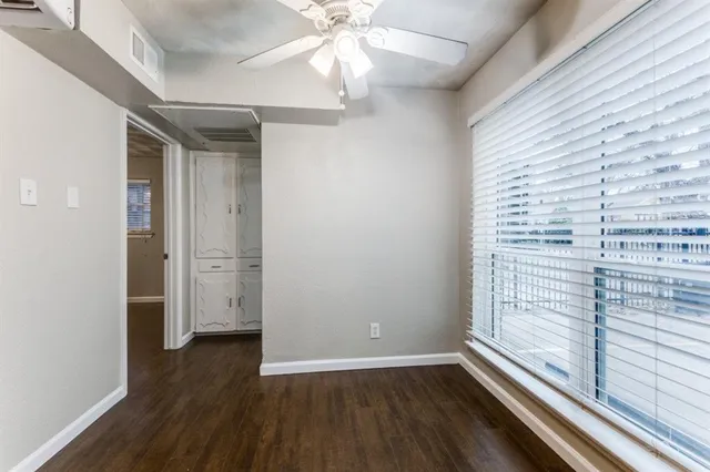 a view of hallway with a ceiling fan and wooden floor