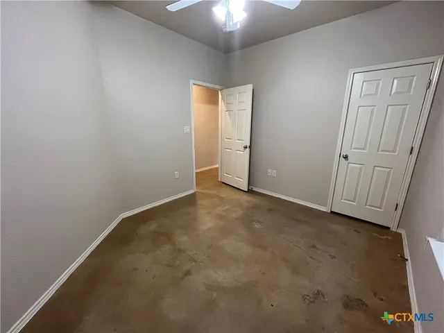 an empty room with a ceiling fan