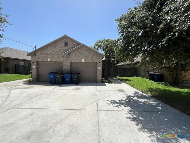 a view of a house with a yard and garage