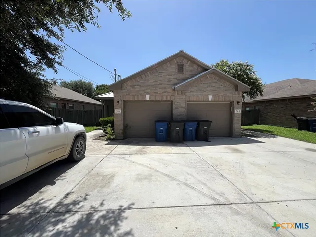 a view of a car park in front of house