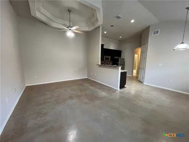 a view of a livingroom with furniture and a ceiling fan