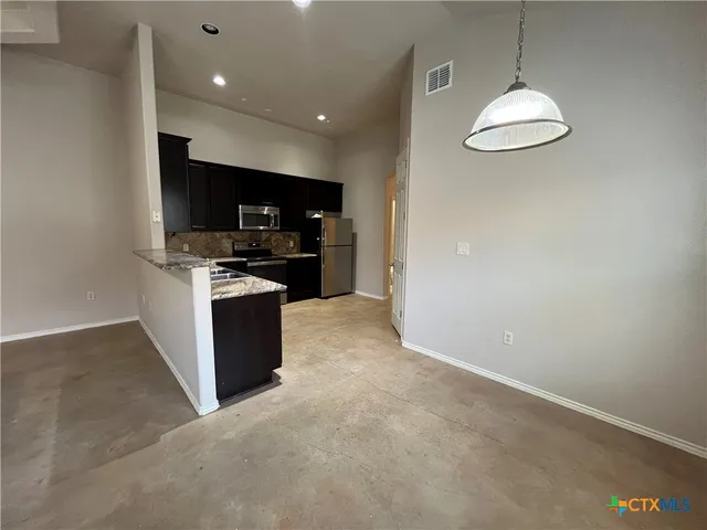 a kitchen with stainless steel appliances granite countertop a stove and a sink