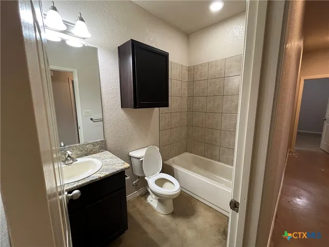 a bathroom with a sink a toilet a mirror and shower