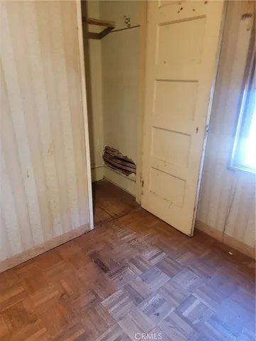 an empty room with wooden floor