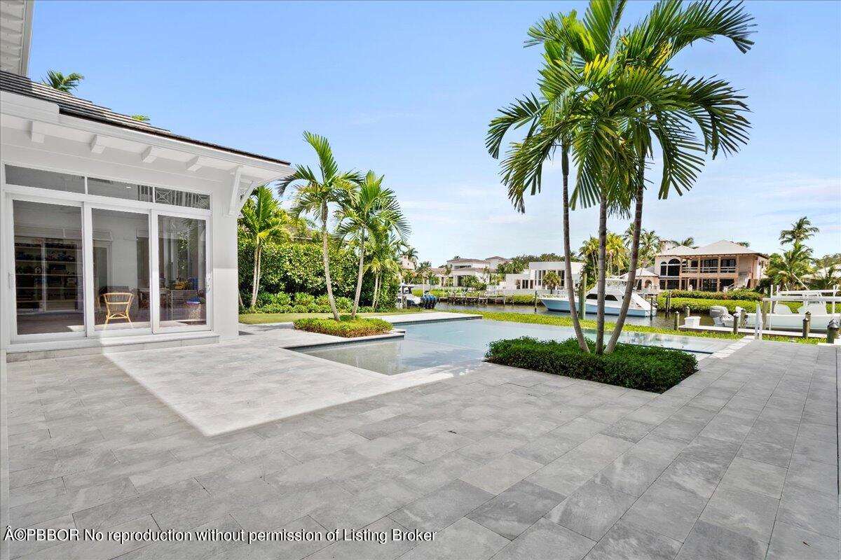 159 Commodore Drive Jupiter, FL 33477 - Photo 3 of 20 a view of a garden with palm trees