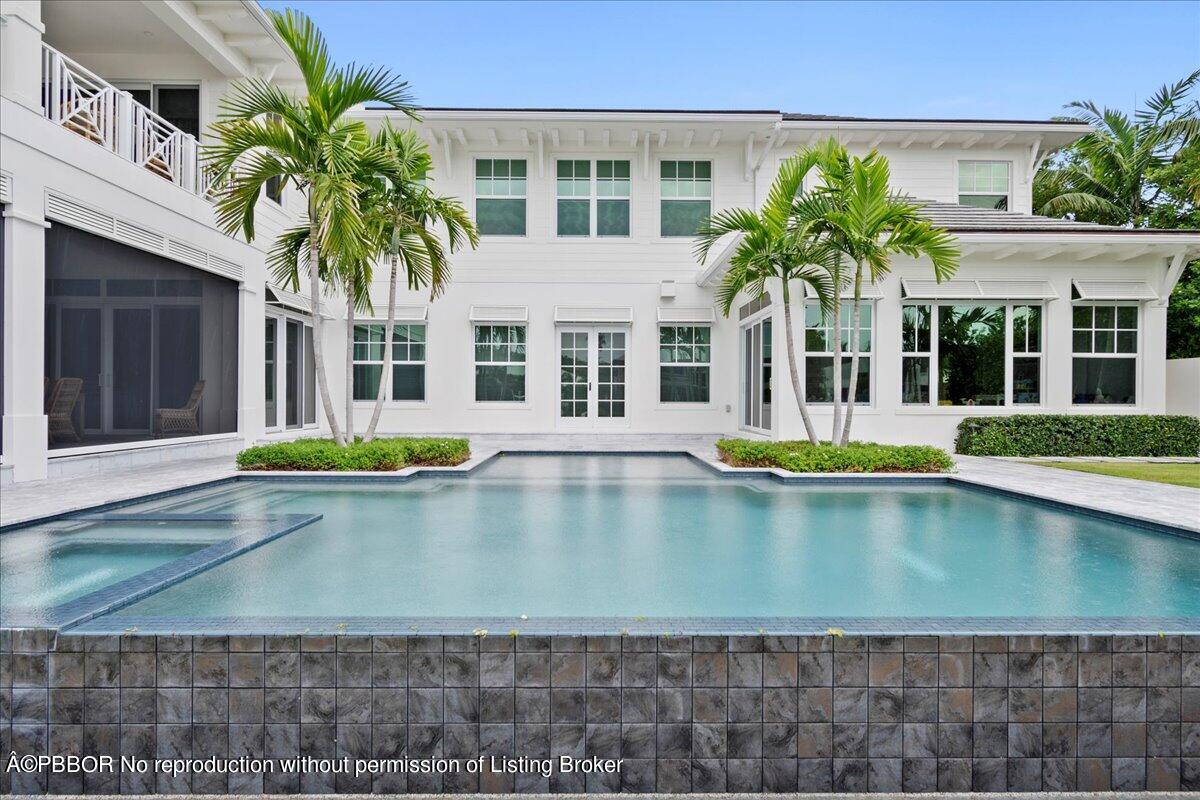 159 Commodore Drive Jupiter, FL 33477 - Photo 10 of 20 a view of a white building with a swimming pool