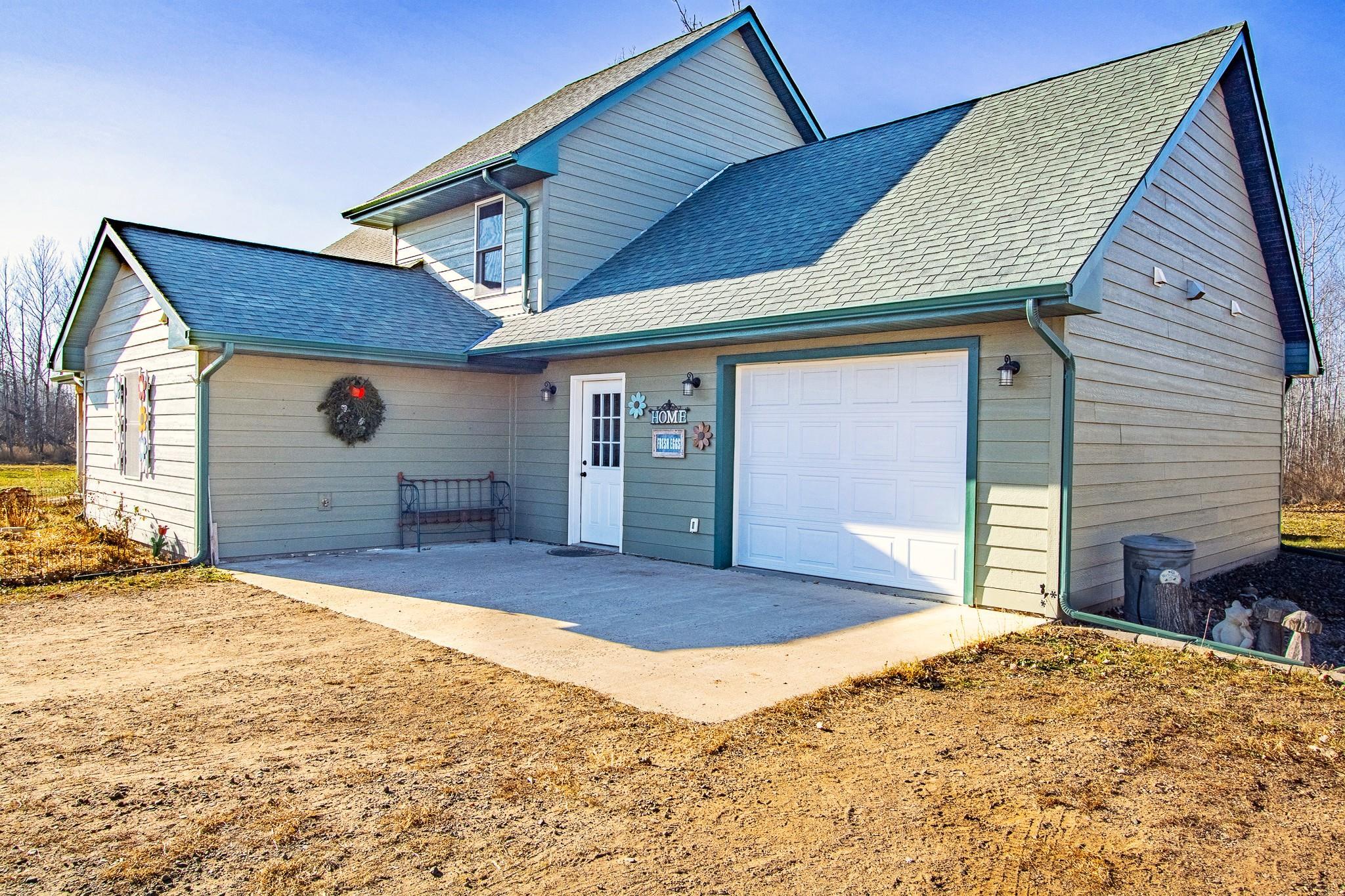 6014 Brown Road Kettle River, MN 55757 - Photo 3 of 54 View of front of home with a shingled roof, an attached garage, and driveway