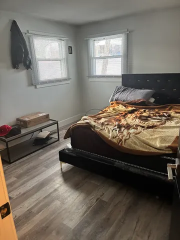 a bed sitting in a bedroom next to a window