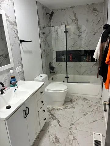 a bathroom with a sink toilet and shower