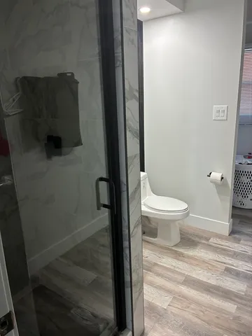 a bathroom with a toilet and a shower